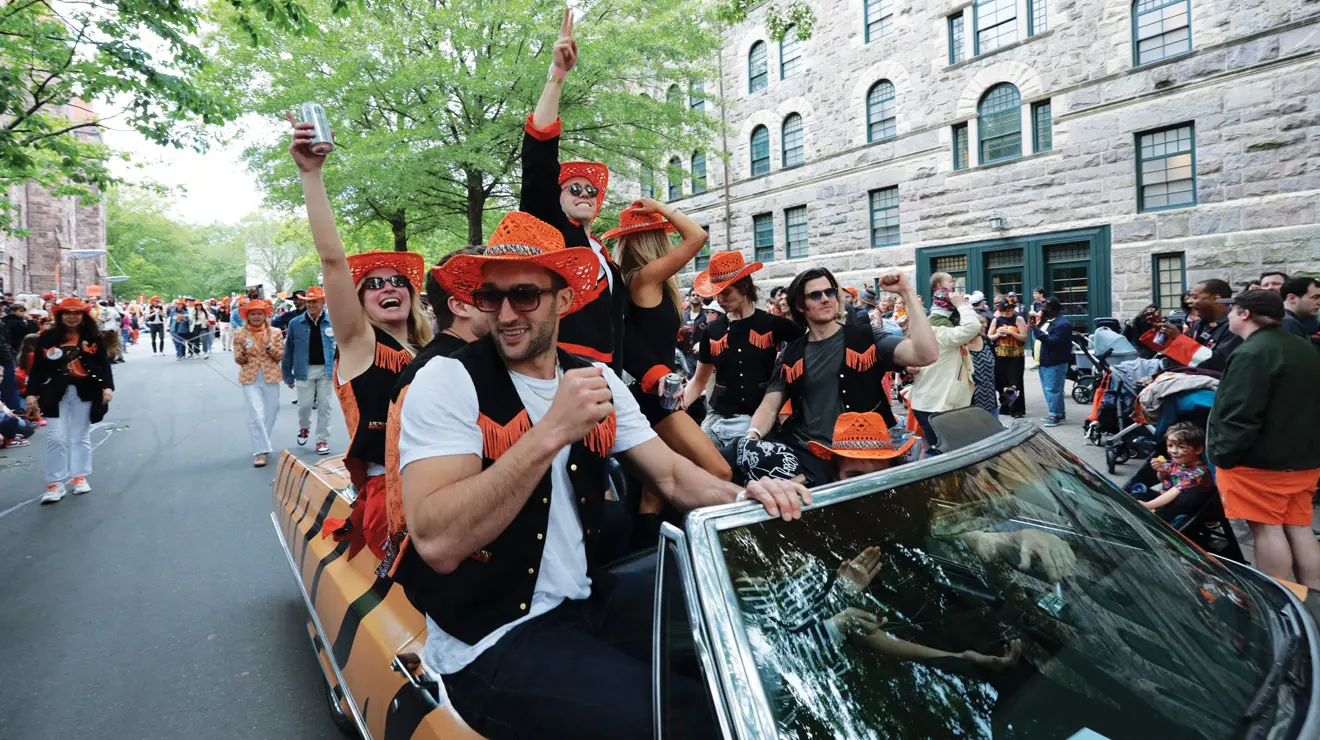 Friends and family members of the Class of 1985 ride in style wearing cowboy hats and vests