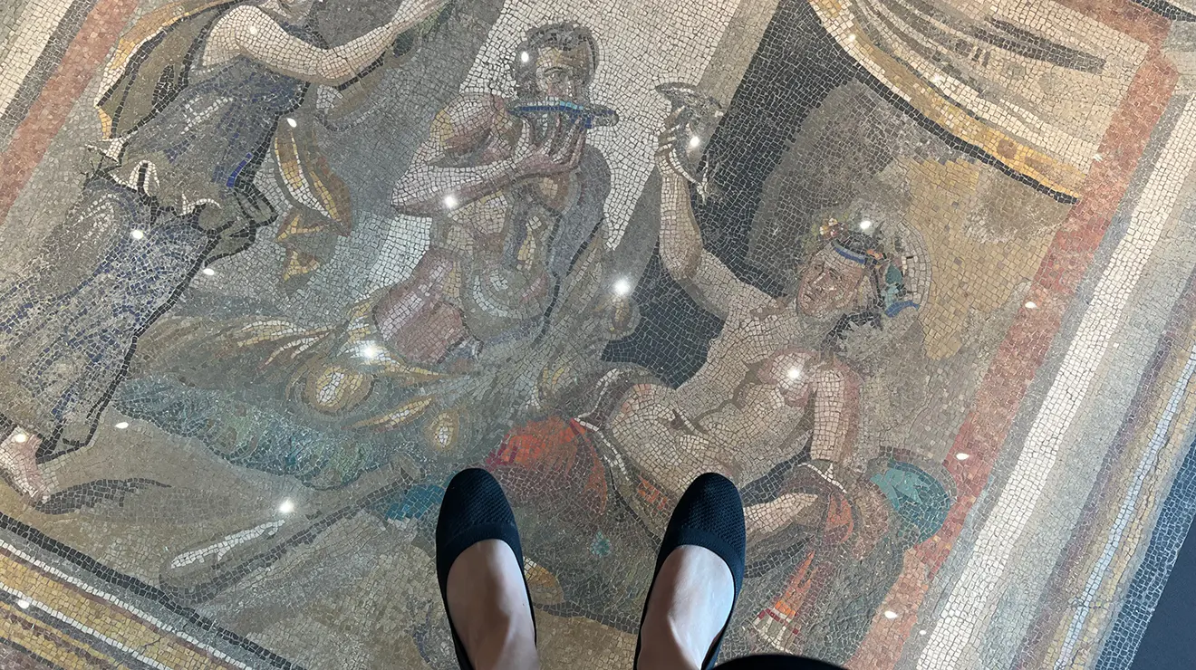 ARTMUSEUM_Floor_mosaic_feet.jpg Two feet above a Roman mosaic set under glass in the floor.