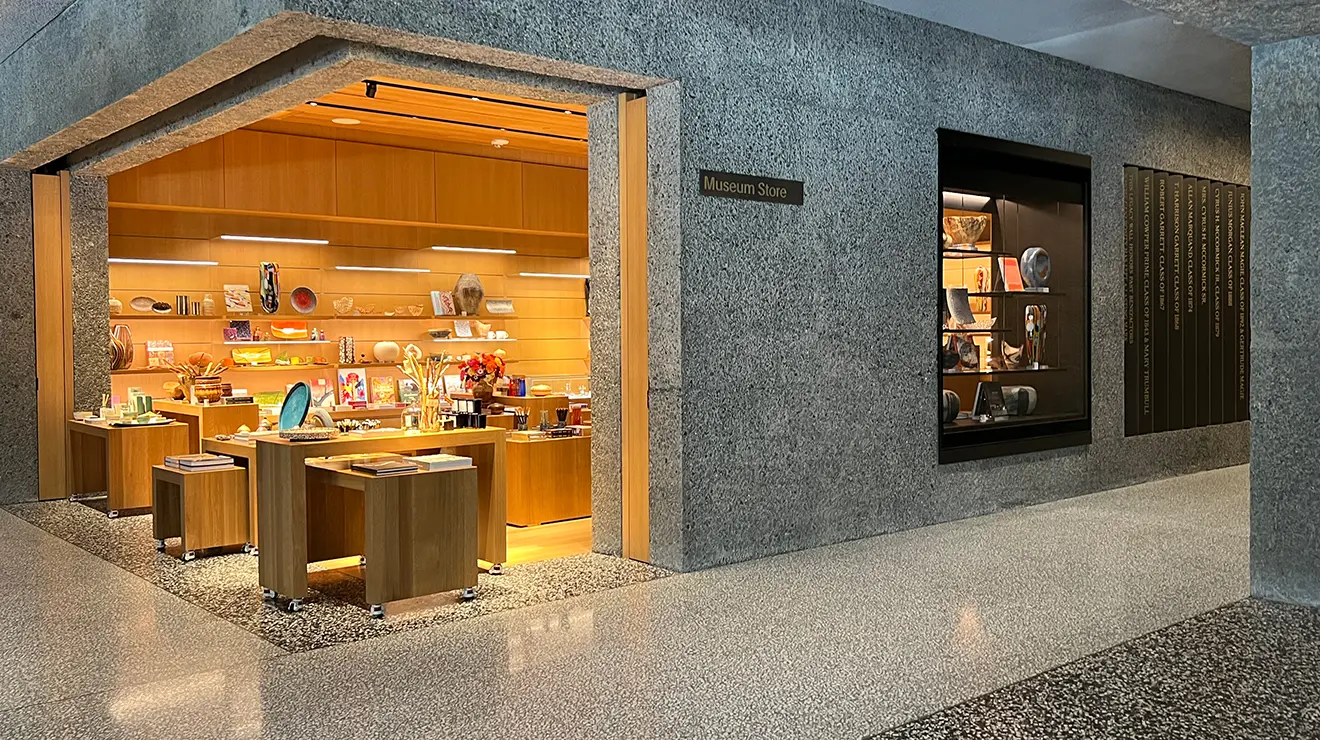 ARTMUSEUM_Museum_store.jpg The museum's store is lit up compared with the dark concrete walls outside it.