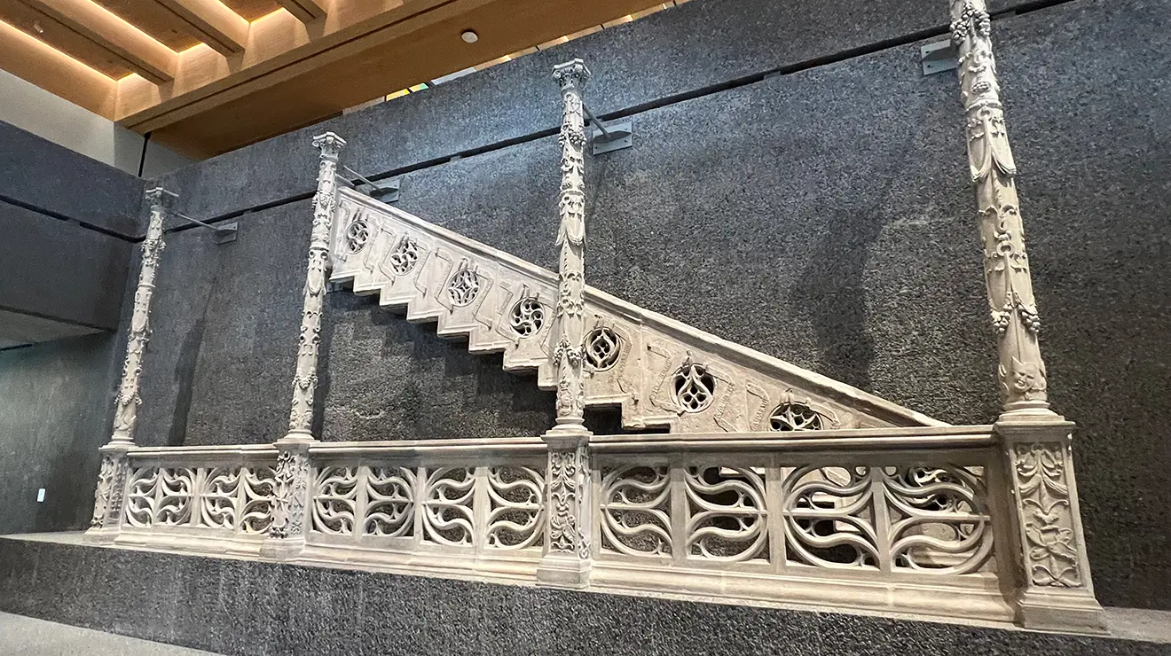 ARTMUSEUM_Spanish_staircase.jpg A white stone railing, four carved pillars, and side of a Spanish staircase.