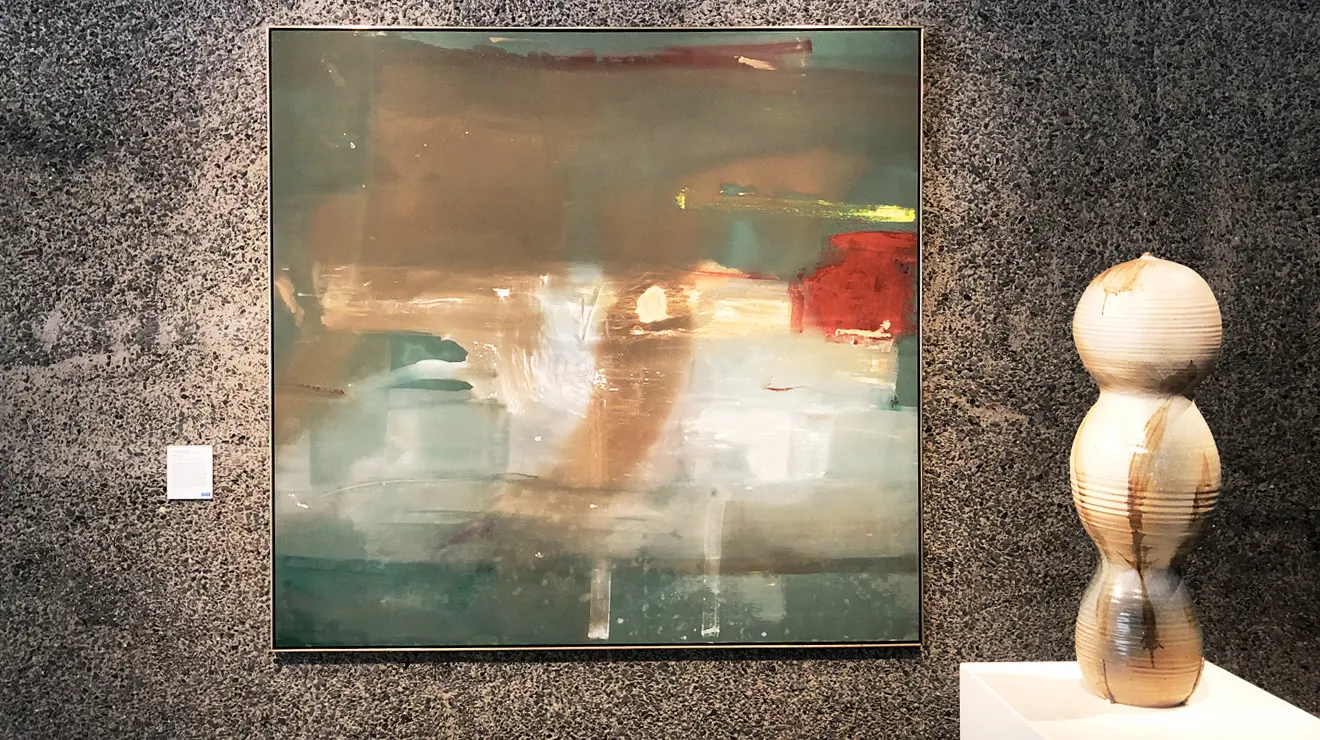 ART_White Tamarind and Belfry.jpg A painting next to a ceramic statue shaped like three balls stacked.