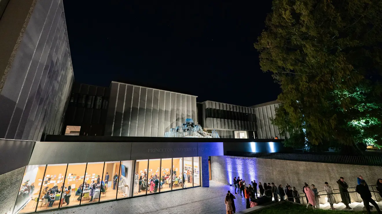 PAUM OPENING_Night Shot.jpg A view of the the Princeton University Art Museum on opening night where crowds of people can be seen through the windows.