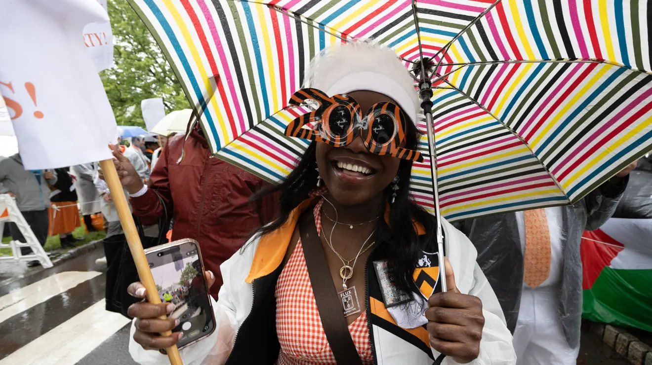 A woman wears tiger-striped sunglasses in the shape of "200."