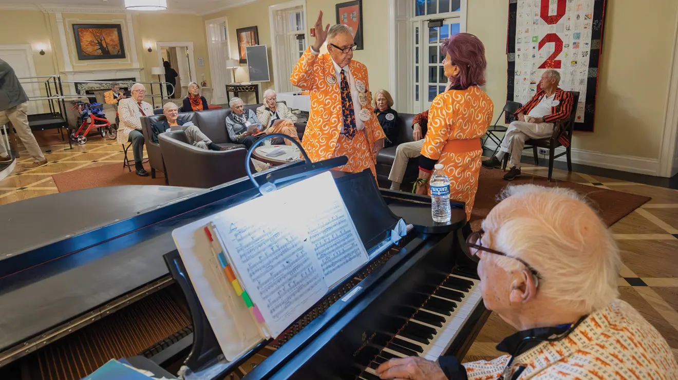REUNIONS_Old Guard.jpg Eric Doten ’61 dances with his wife, Lynne Hunt Doten, while Jim Freund ’56 plays the piano.