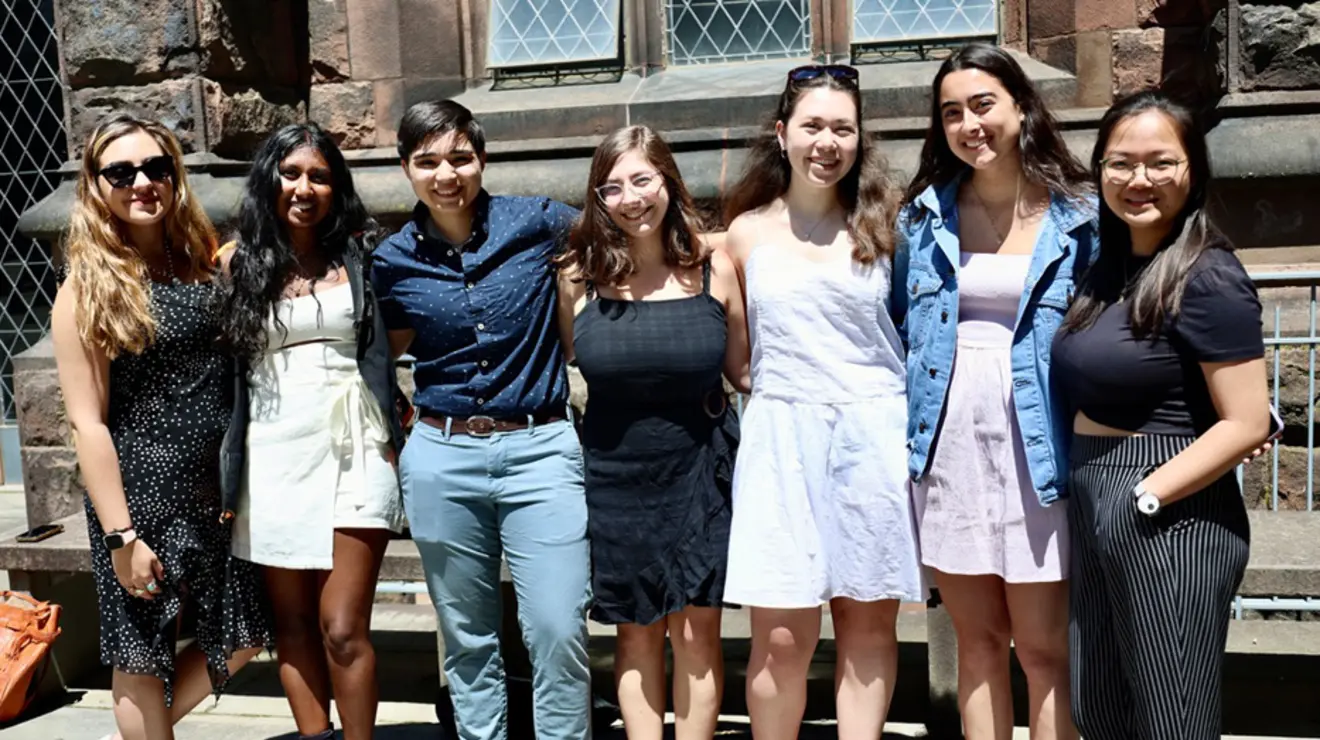 Seven young people smile for the camera.