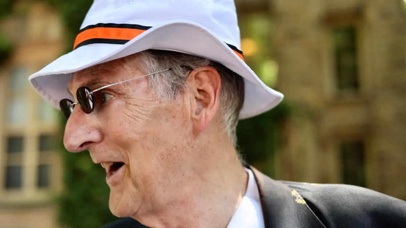 Man in a floppy white hat with an orange band.