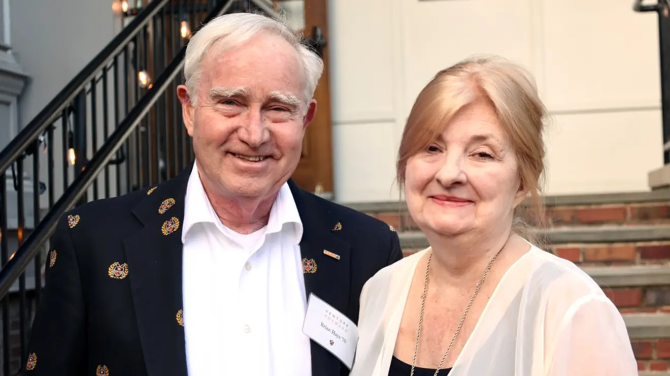 A man and a woman smile for the camera.