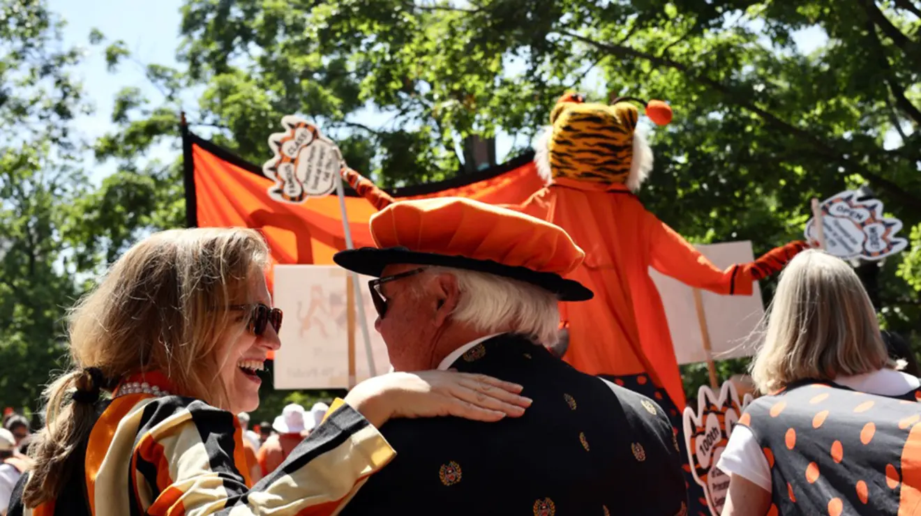 People march in the P-rade with a tall tiger.