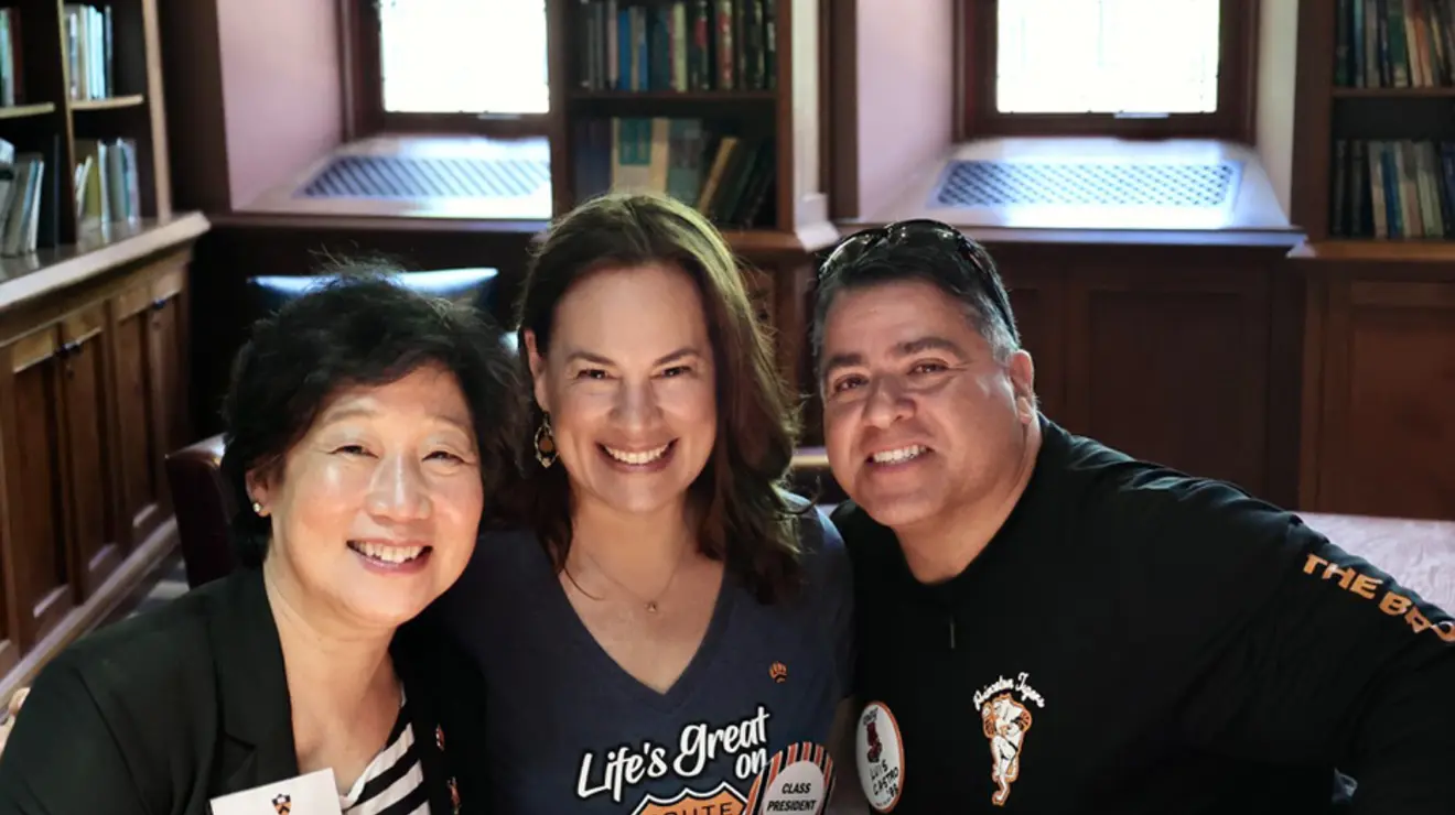 Three people smile for the camera; one wears a shirt reading, "Life's great on Route 88."
