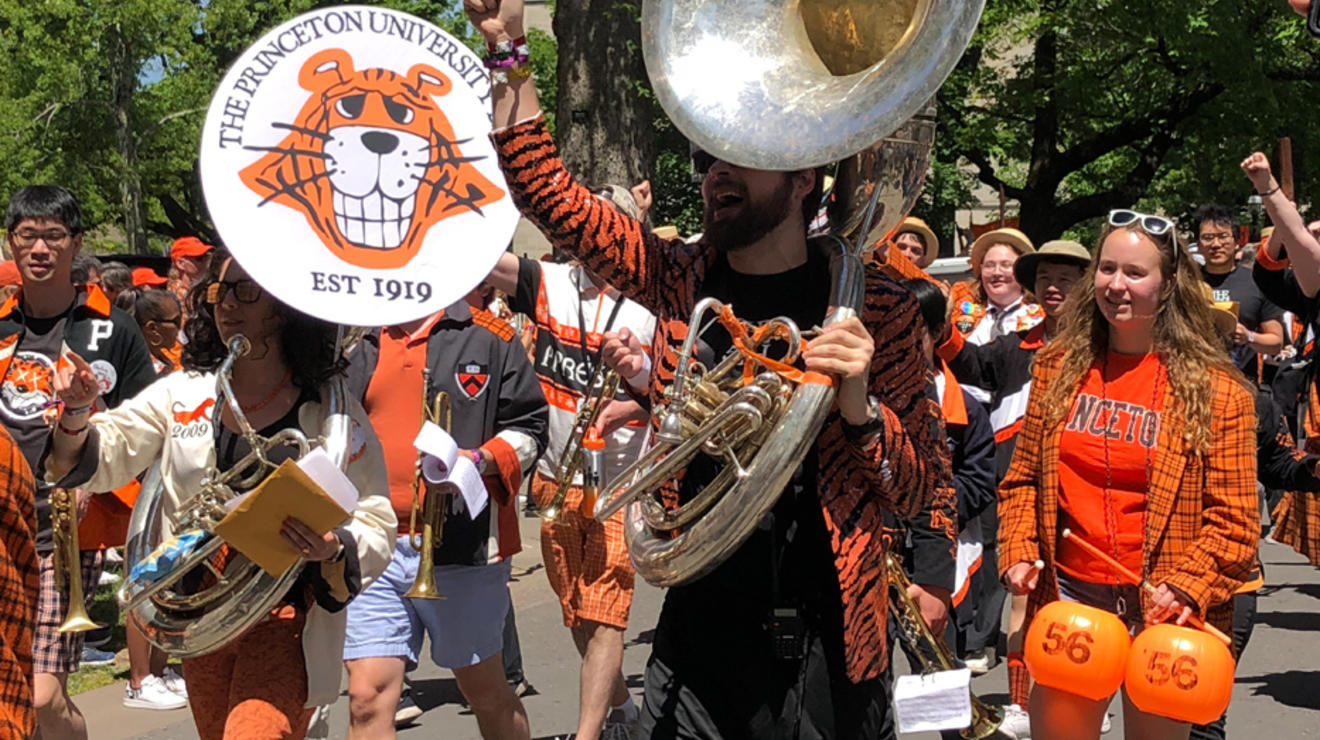 Band members march in the P-rade; one holds a tuba. 