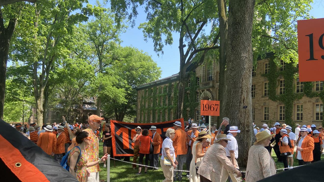 The Class of 1967 and others hold their orange class banners in front of Nassau Hall, getting ready for the P-rade.