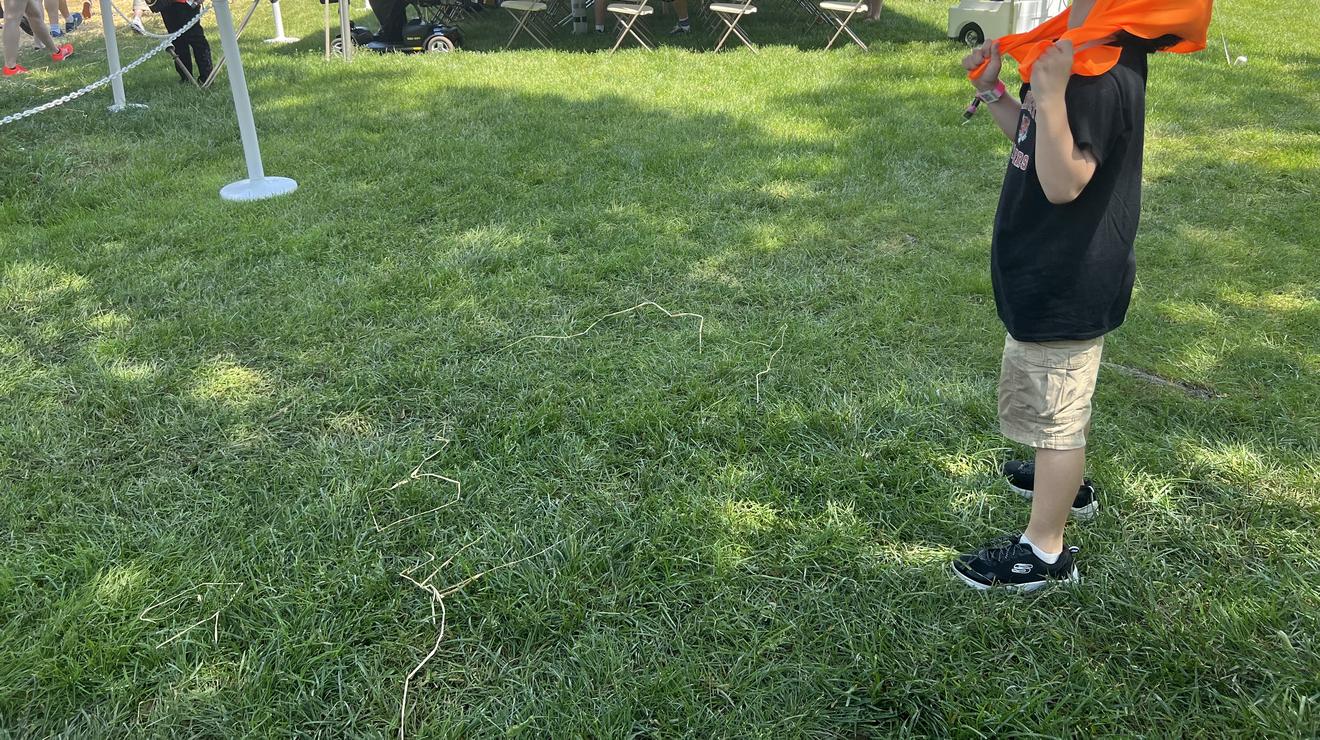 Adam Marsi, 7, grandson of Bruce Douglas ’47, cools off with a towel at the P-rade.