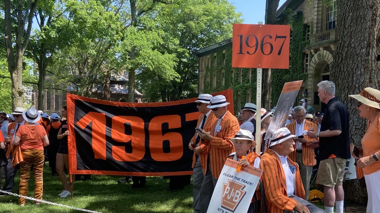 The Class of 1967 hold their orange class banners in front of Nassau Hall, getting ready for the P-rade.