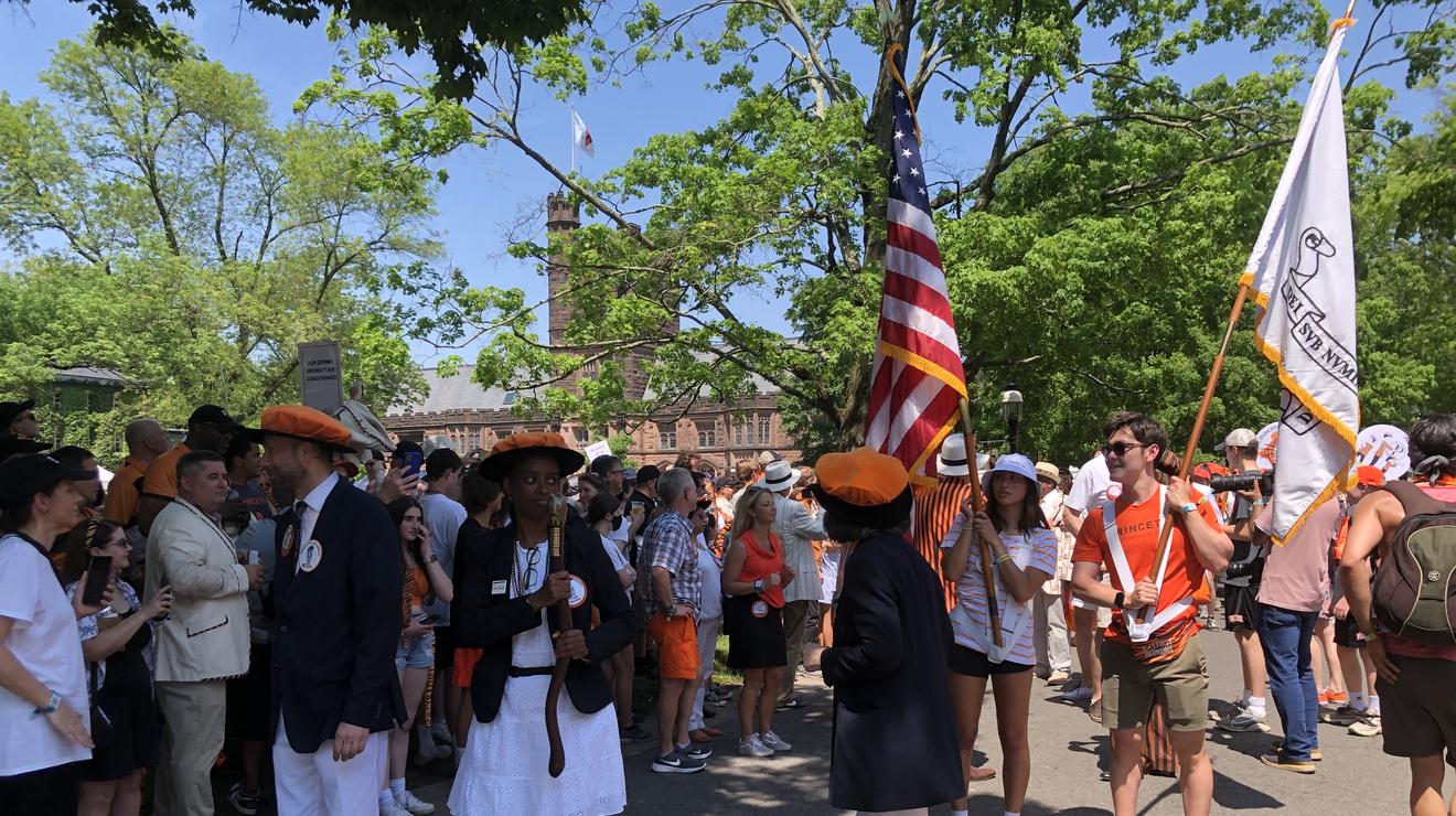 Alumni hold flags waiting for the P-rade to begin.