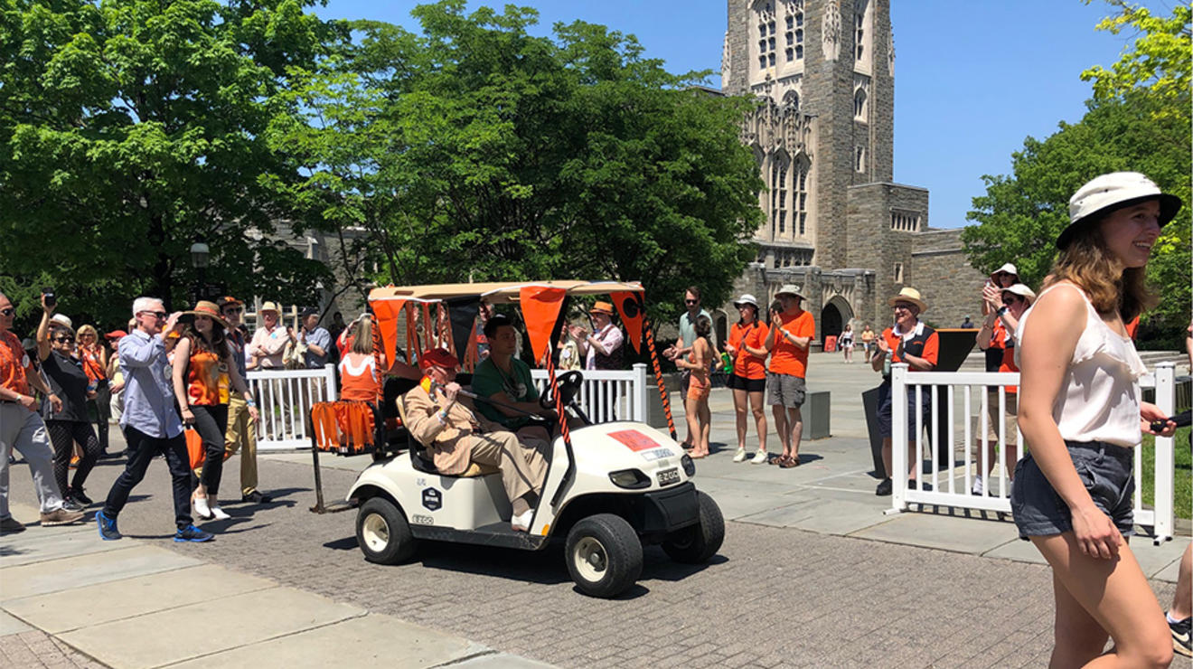 Joe Schein ’37 heads to the P-rade in a golf cart.