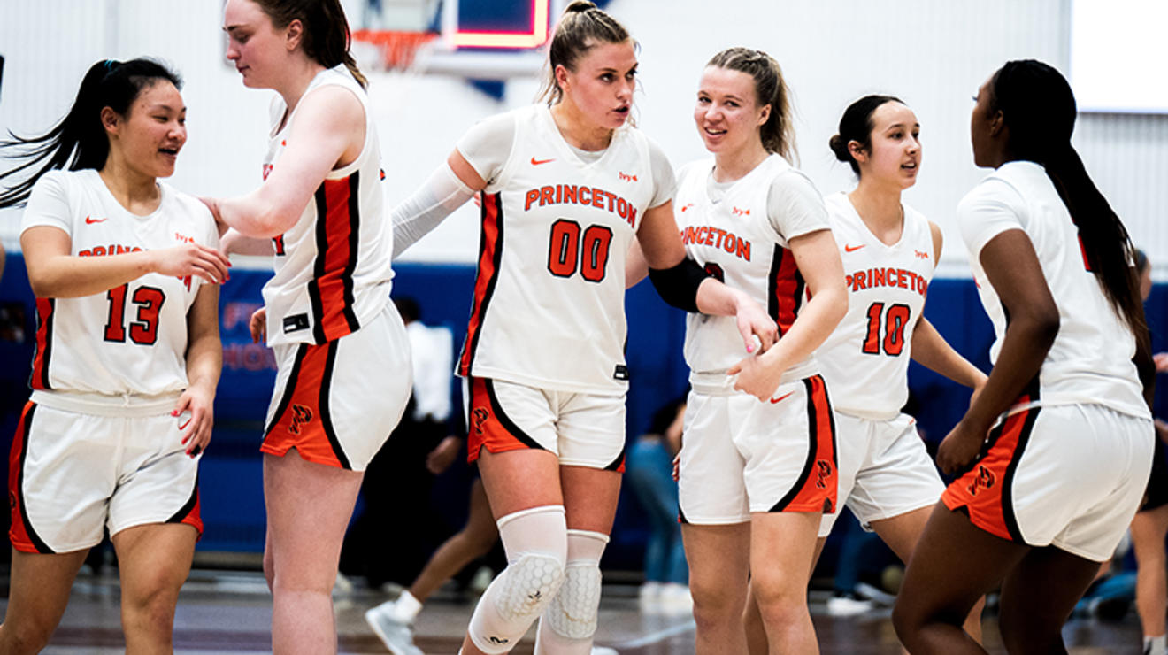 Ellie Mitchell ’24, center, greets her teammates in the Penn game. 