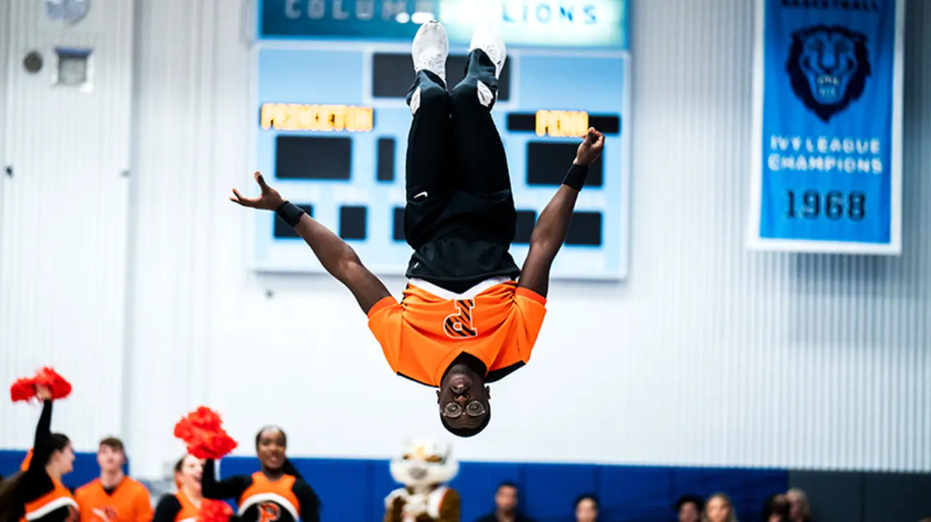 Lem slideshow-3-Cheerleader_Penn.jpg Cheerleader leaps and flips through the air