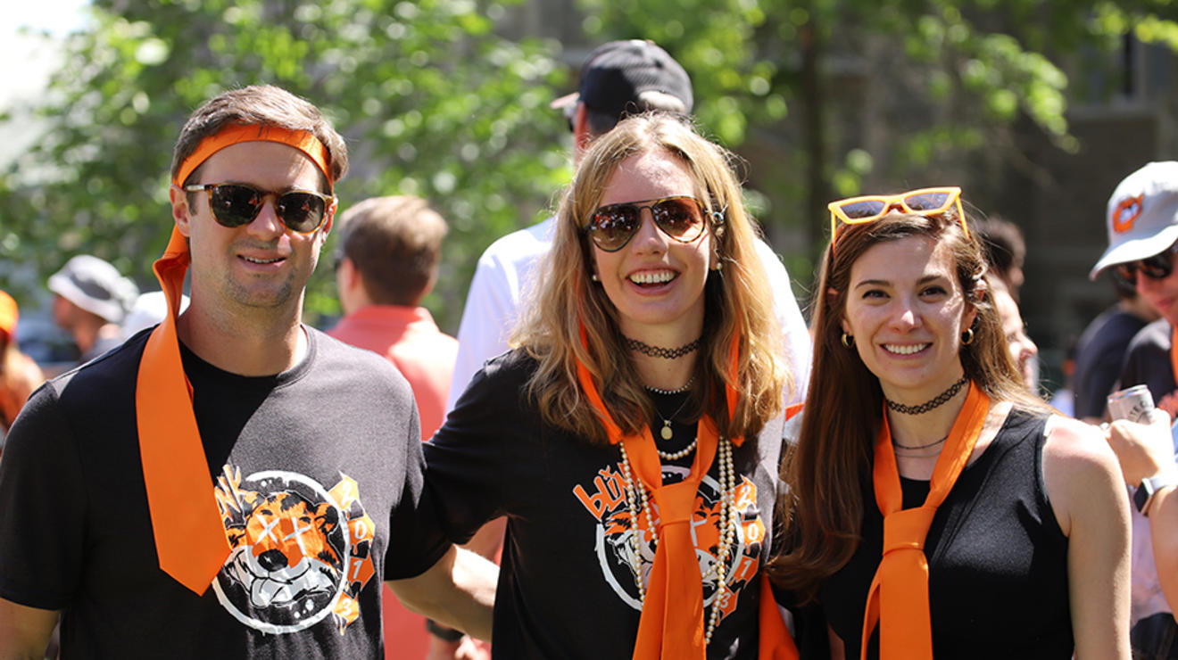 Three people wear orange ties in the P-rade.