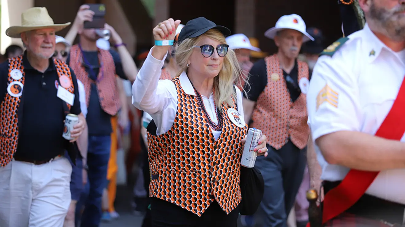 PRADE23_Allison-18.jpg A woman with orange nail polish raises her fist during the P-rade.