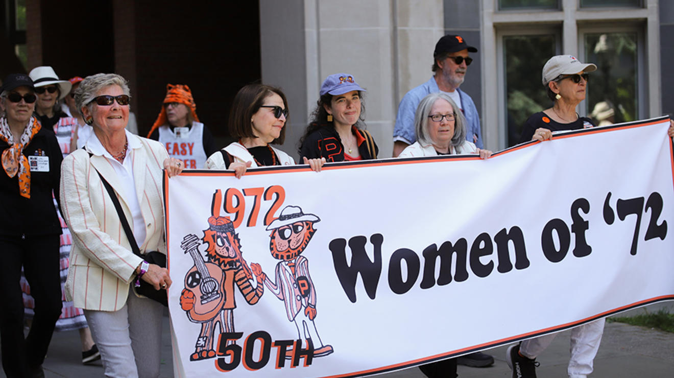 Women carry a "Women of ’72" banner in the P-rade.