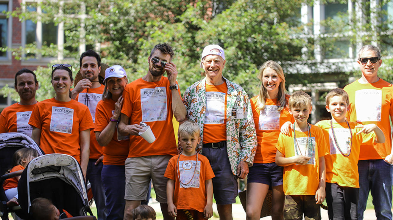 A family wears matching orange shirts in the P-rade.