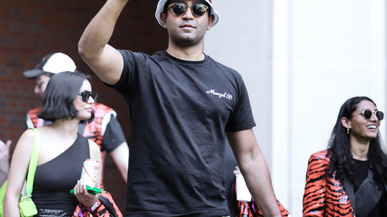 A guy flashes the peace sign.
