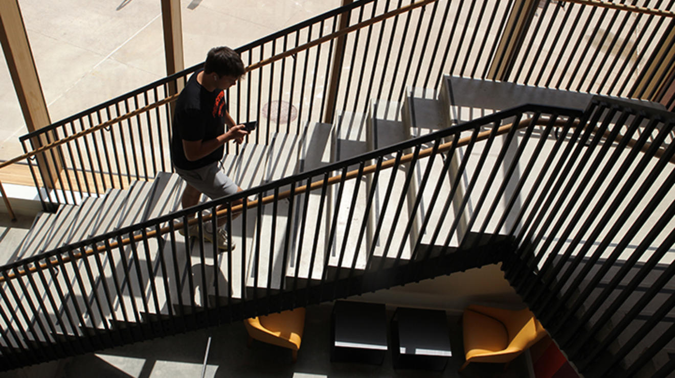 David Heath ’25 of Sparta, New Jersey, a player on the football team, walks up the stairs in Yeh College.