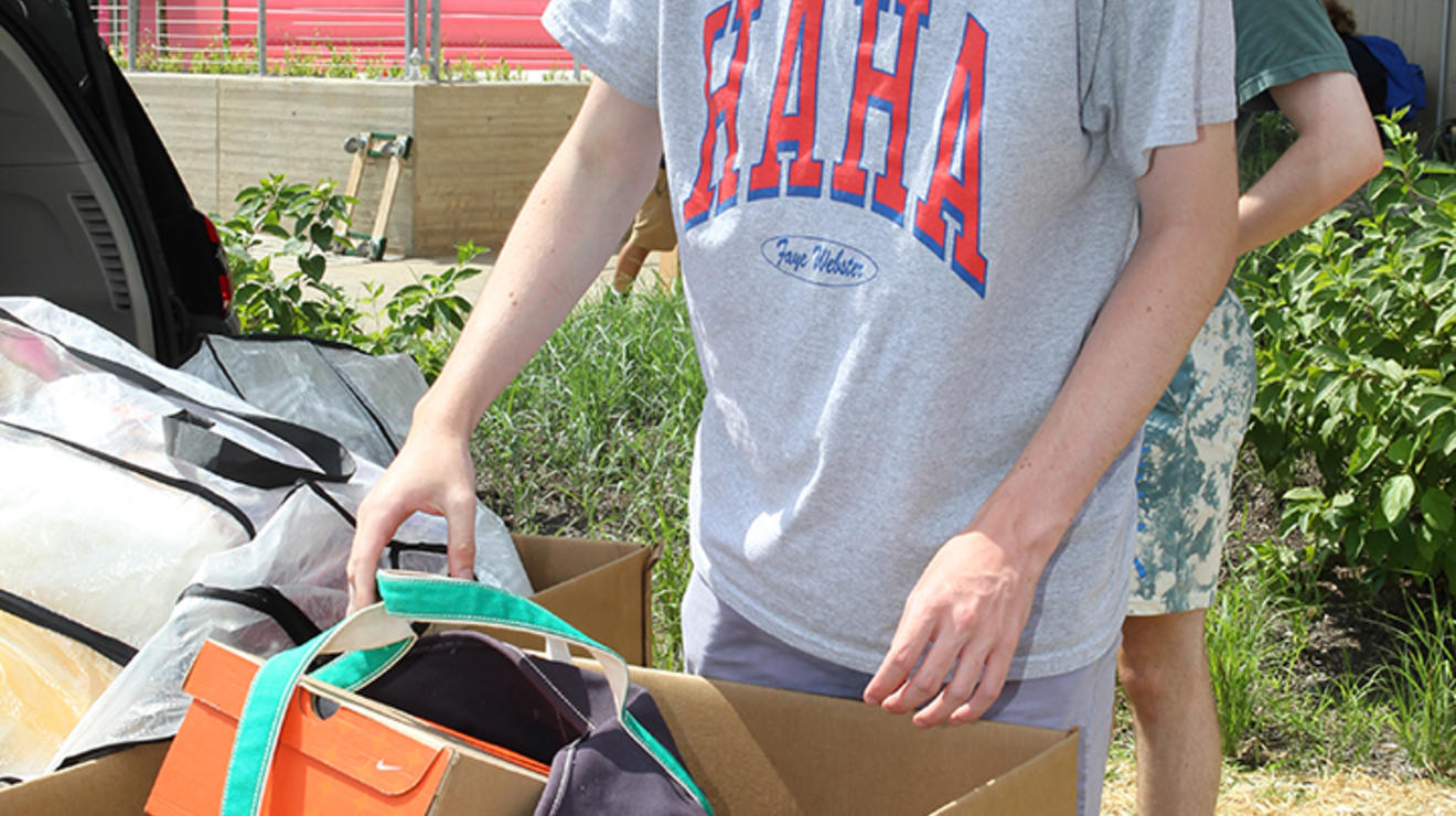 Harry Gorman ’26 stands with the boxes he's moving into Princeton.