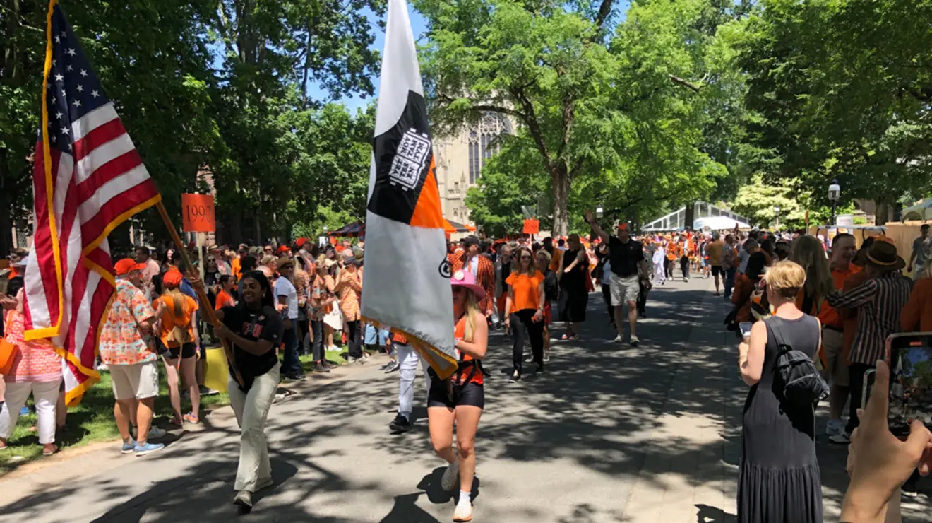 Photo May 27 2023, 2 06 28 PM.jpg Alumni holding flags march in the P-rade.