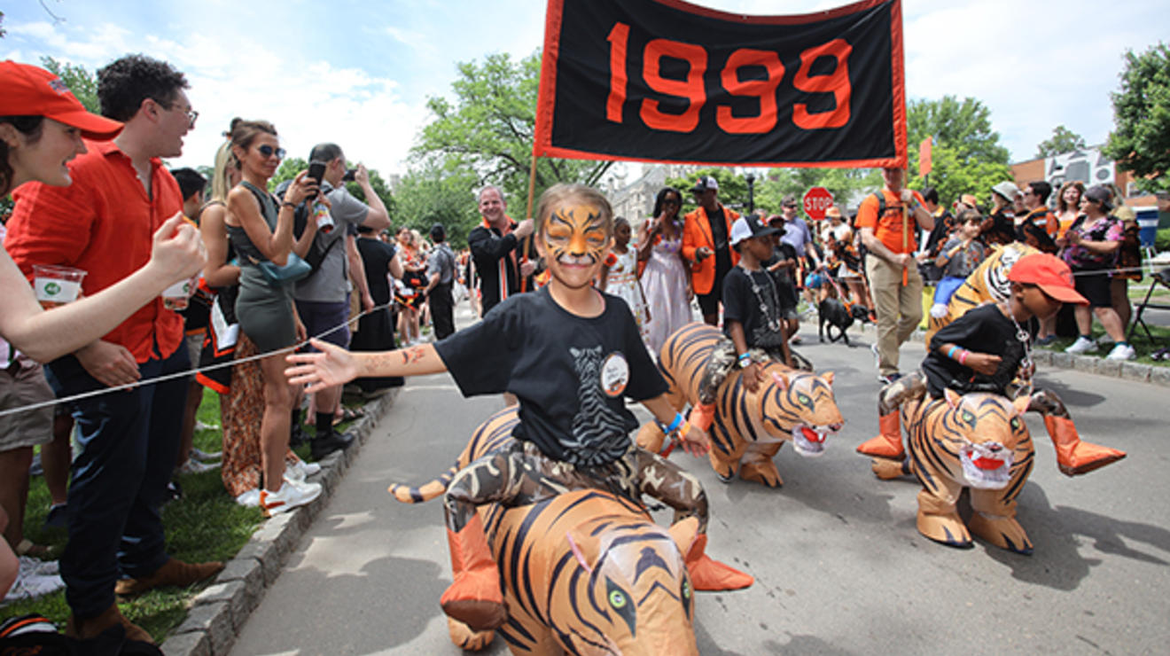 Children "ride" on inflatable tigers with the Class of 1999 in the P-rade.