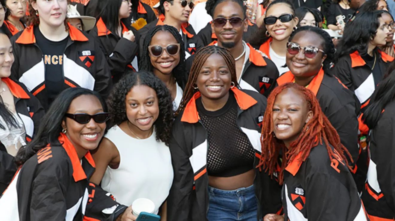 ReunionsSlideshow11.jpg Friends smile and pose for a photo at the P-rade.