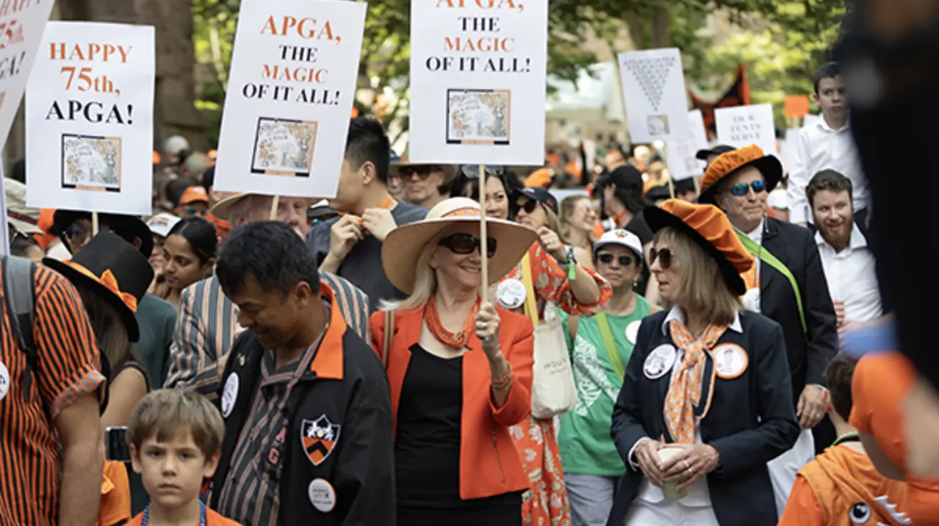 ReunionsSlideshow21.jpg People marching in the P-rade carry signs that read "APGA, the magic of it all!"