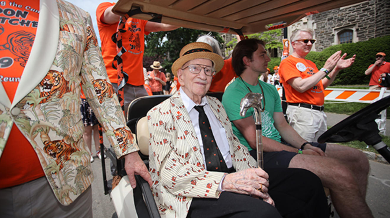 Don Fletcher ’30 *51 holds the silver Class of 1923 Cane while riding in a golf cart at the P-rade. 