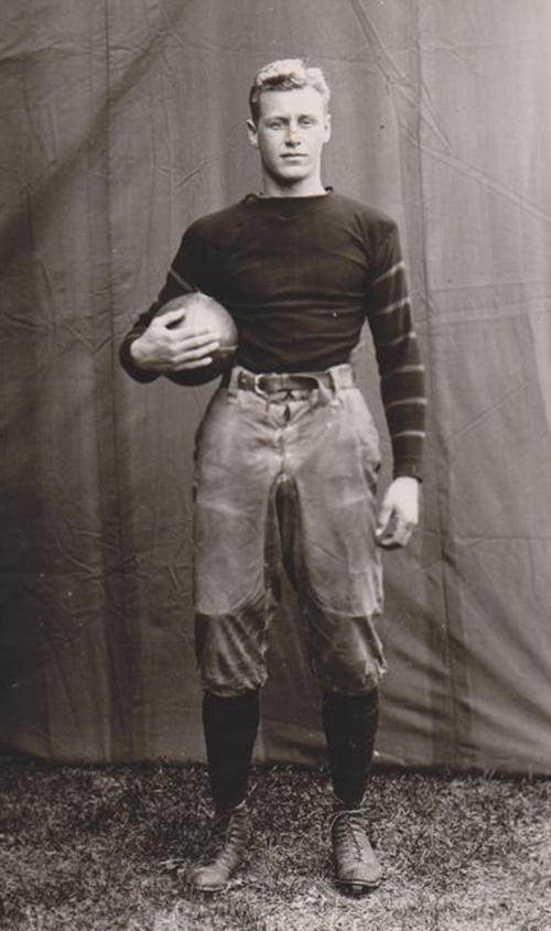 HobeyBaker2_FootballCaptain1913.jpg Black and white photo of Hobey Baker holding a football.