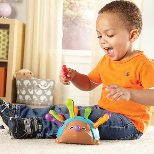 A child plays with Learning Resources’ Spike the Fine Motor Hedgehog toy