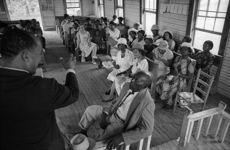 Valley View, Miss. Service at country church:  St. Paul's Missionary Baptist Church, summer '64. Congregation members listening to Rev. Percy Gordon. Man in the foreground is a deacon.