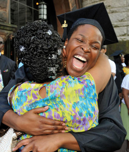 Cecelia Ogechi Oparah ’13 hugs a roommate’s mother at the Pan-African ceremony June 2.