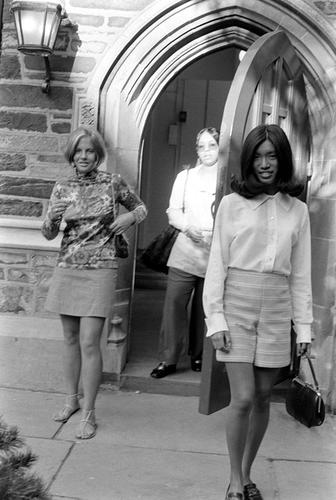 Three women leaving building