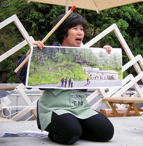 Inn owner Akiko Iwasaki describes her plans to replace a ­tsunami evacuation path with a broad stairway for outdoor performances.