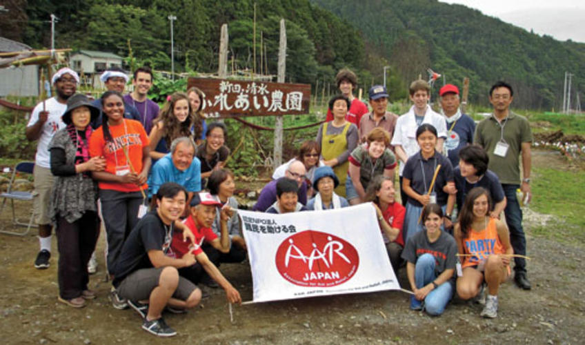 Global Seminar participants gather with residents, local officials, and relief workers at a temporary housing complex for elderly evacuees in Onagawa.