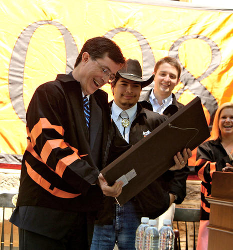 Stephen Colbert, left, receives an "Understandable Vanity Award" from seniors including Class Day co-chairman Jonathan Galeano (from Texas) and class president Tom Haine. 