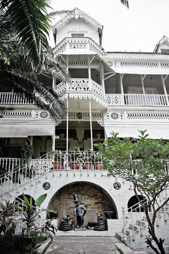 The Hotel Oloffson, with a statue of Baron Samedi, a Vodou deity, in front.