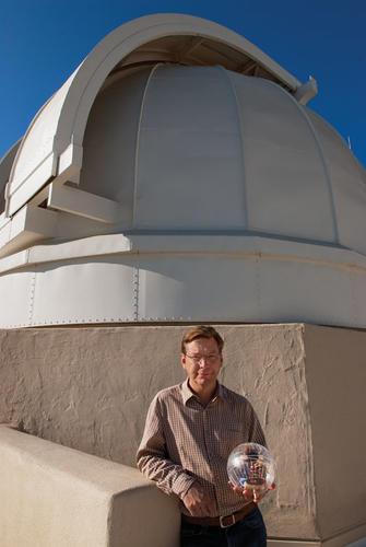 Mike Brown ’87 holds his lunar rover on the roof of Caltech’s historic solar observatory.