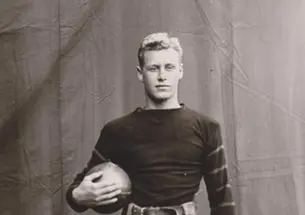 HobeyBaker2_FootballCaptain1913.jpg Black and white photo of Hobey Baker holding a football.