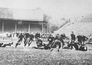 Black and white photo of Hobey Baker and his team on the field playing football.