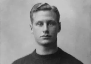 Black and white photo of Hobey Baker in his Princeton sweater. 