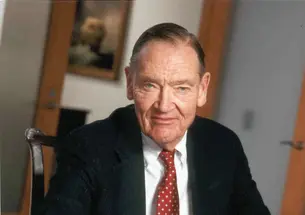 Image of John Bogle ’51 sitting at a desk