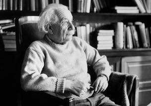 Albert Einstein Seated in his office.