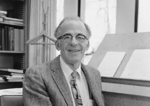 Lyman Spitzer *38 sits at his desk.