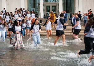 SPIA students celebrate in the Fountain of Freedom